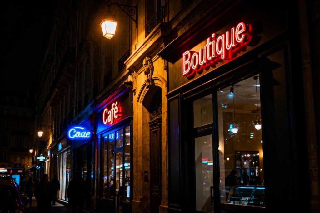 Realme GT 8 Pro night photography sample showing low-light city streets with neon signs, street lamps, and storefront displays with controlled highlights and detailed shadows